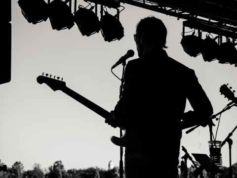 Weekend Event Guide / 1-3 April 2022 silhouette photo of man holding guitar