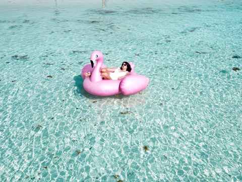 Weekend Event Guide | Friday 2 December-Sunday 4 December 2022 woman lying on pink flamingo bouy on body of water