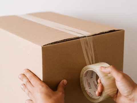 Crispin Hull / Why renters are being done over crop man sealing carton box with tape