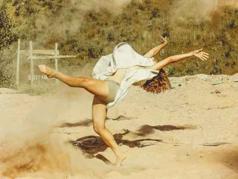 The Week/End Guide. woman wearing white dress dancing on brown sand